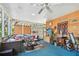 Covered porch featuring ample seating, wood paneling, and a view of the outdoor foliage at 11209 Spring St, Largo, FL 33774