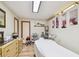 Inviting spa room with massage table, ample storage, light wood floors, and bright lighting to create a relaxing atmosphere at 11209 Spring St, Largo, FL 33774