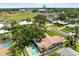 Aerial view of property near Dunedin High School, showcasing a pool and lush greenery at 1140 Mcfarland St, Dunedin, FL 34698