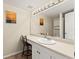 Bathroom featuring a spacious vanity, a large mirror, and neutral decor at 1140 Mcfarland St, Dunedin, FL 34698