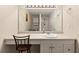 Bathroom with a white single sink vanity featuring a large mirror and a view of the toilet and shower at 1140 Mcfarland St, Dunedin, FL 34698