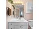 Bathroom featuring a white vanity, mirror with lighting, and decorative accents at 1140 Mcfarland St, Dunedin, FL 34698