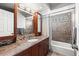 Bathroom featuring granite counters, a tile shower, and modern fixtures at 1140 Mcfarland St, Dunedin, FL 34698
