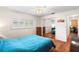 Bright bedroom featuring a ceiling fan, a mirrored closet door, and wood flooring at 1140 Mcfarland St, Dunedin, FL 34698