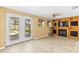 Bonus room showcasing French doors to the pool, a ceiling fan, and a built-in entertainment center at 1140 Mcfarland St, Dunedin, FL 34698