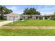 Charming single-story home with a well-manicured lawn and a two-car garage at 1140 Mcfarland St, Dunedin, FL 34698