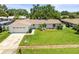 Charming home with manicured lawn, well-maintained landscaping, and a two-car garage at 1140 Mcfarland St, Dunedin, FL 34698