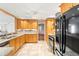 Bright kitchen featuring wood cabinets, granite counters, and stainless steel appliances at 1140 Mcfarland St, Dunedin, FL 34698