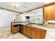 Open kitchen design featuring wood cabinets and granite countertops at 1140 Mcfarland St, Dunedin, FL 34698