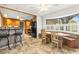 Open kitchen flowing to dining area with a large bright window at 1140 Mcfarland St, Dunedin, FL 34698