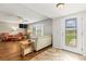 Inviting living room showcasing tile floors, a bay window, and comfortable seating at 1140 Mcfarland St, Dunedin, FL 34698