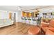 Open-concept living area leads to a kitchen with bar seating and dining area at 1140 Mcfarland St, Dunedin, FL 34698