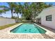 Swimming pool with clear blue water and a view of lush greenery at 1140 Mcfarland St, Dunedin, FL 34698