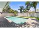 Beautiful pool area with refreshing water, lush greenery, and a clean fence surround at 1140 Mcfarland St, Dunedin, FL 34698
