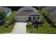 Elevated front exterior showing the manicured lawn, garden, and two car garage at 11252 Merganser Way, New Port Richey, FL 34654