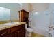 Well-maintained bathroom with wooden vanity and shower-tub combination, complete with tiled floors at 11252 Merganser Way, New Port Richey, FL 34654