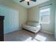 Bright bedroom with a closet, a love seat by the window and a ceiling fan at 11252 Merganser Way, New Port Richey, FL 34654