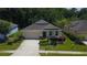 An elevated front exterior showing the manicured lawn, garden, and two car garage at 11252 Merganser Way, New Port Richey, FL 34654