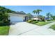 Charming single-story home featuring a well-manicured lawn, landscaping, and a two-car garage at 11252 Merganser Way, New Port Richey, FL 34654
