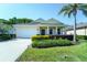 Charming single-story home featuring a well-manicured lawn, landscaping, and a two-car garage at 11252 Merganser Way, New Port Richey, FL 34654