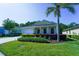 Charming single-story home featuring a well-manicured lawn, landscaping, and a two-car garage at 11252 Merganser Way, New Port Richey, FL 34654