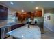 Bright kitchen with stainless steel appliances and granite countertops offer modern convenience at 11252 Merganser Way, New Port Richey, FL 34654