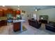 Modern kitchen boasts stainless steel appliances, granite countertops, and stylish wood cabinets at 11252 Merganser Way, New Port Richey, FL 34654