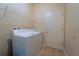 Bright laundry room with washer, dryer, and shelving, offering convenient organization at 11252 Merganser Way, New Port Richey, FL 34654
