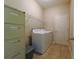 Functional laundry room equipped with a washer, dryer, shelving, and ample storage space at 11252 Merganser Way, New Port Richey, FL 34654
