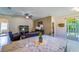 Open living room with granite countertops, tile floors, and leather furniture at 11252 Merganser Way, New Port Richey, FL 34654