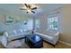 Bright living room with white sofas, neutral walls, and many windows at 11252 Merganser Way, New Port Richey, FL 34654