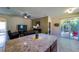 Living room with open floor plan leading to a covered patio and screened enclosure at 11252 Merganser Way, New Port Richey, FL 34654
