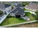 Aerial view of a well-maintained property showcasing the backyard, patio, and surrounding landscape at 12327 Eagle Swoop Pl, Riverview, FL 33579