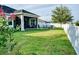 Landscaped backyard featuring a fire pit area and screened patio at 12327 Eagle Swoop Pl, Riverview, FL 33579