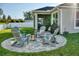 Outdoor patio featuring an inviting fire pit surrounded by comfortable Adirondack chairs at 12327 Eagle Swoop Pl, Riverview, FL 33579