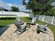Backyard with fire pit and Adirondack chairs for outdoor entertaining at 12327 Eagle Swoop Pl, Riverview, FL 33579