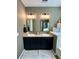 Bathroom featuring dual sinks, granite counters, and modern light fixtures at 12327 Eagle Swoop Pl, Riverview, FL 33579