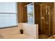Bathroom with a modern glass-enclosed shower and a window providing natural light at 12327 Eagle Swoop Pl, Riverview, FL 33579