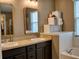 Bathroom with double sinks, a bathtub, and ample storage at 12327 Eagle Swoop Pl, Riverview, FL 33579