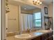 Bright bathroom features double sinks, a large mirror, and a shower/tub combo, perfect for a refreshing start at 12327 Eagle Swoop Pl, Riverview, FL 33579