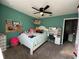 Fun and colorful bedroom, featuring whimsical décor, a desk, and plenty of storage for toys and keepsakes at 12327 Eagle Swoop Pl, Riverview, FL 33579
