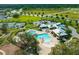 Aerial shot of the community pool and recreation area with tennis courts, clubhouse, pool, and ample parking at 12327 Eagle Swoop Pl, Riverview, FL 33579