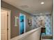 Bright hallway with floral wallpaper, with doors leading to other rooms, creating a seamless flow throughout the home at 12327 Eagle Swoop Pl, Riverview, FL 33579