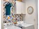 Well-lit laundry room with modern appliances, overhead storage, and a stylish accent wall at 12327 Eagle Swoop Pl, Riverview, FL 33579