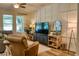 Inviting living room with wood flooring, decorative wall, and comfortable seating at 12327 Eagle Swoop Pl, Riverview, FL 33579