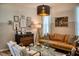 Comfortable living room with a stylish leather sofa, accent chairs, and decorative artwork at 12327 Eagle Swoop Pl, Riverview, FL 33579
