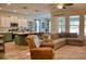 Open-concept living area featuring a kitchen with island seating and a comfortable sectional sofa at 12327 Eagle Swoop Pl, Riverview, FL 33579