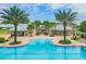 Beautiful community pool surrounded by palm trees and inviting lounge areas perfect for relaxation and socializing at 12327 Eagle Swoop Pl, Riverview, FL 33579