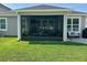 View of the screened patio, complete with fan and comfortable seating area at 12327 Eagle Swoop Pl, Riverview, FL 33579