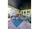 The screened patio features an outdoor dining table with brick pavers and a ceiling fan at 12327 Eagle Swoop Pl, Riverview, FL 33579